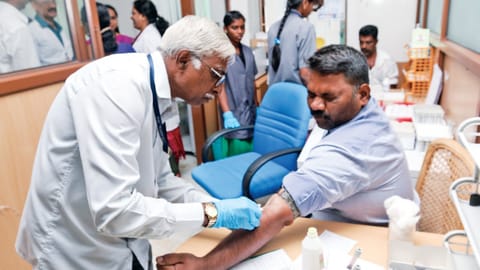 The doctor is giving an injection to the patient
