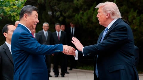 US President Donald Trump, right, shakes hands with Chinese President Xi Jinping while leaving after a visit to the Zhongnanhai Garden in Beijing
