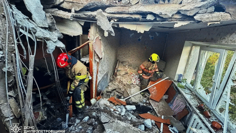 Firefighters put out a fire in a building following a Russian air attack in Dnipropetrovsk region, Ukraine