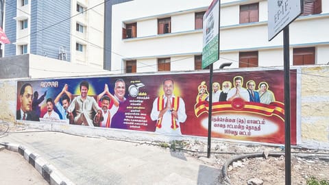 Walls near the MC Raja College Student Hostel are filled with TVK party posters in Saidapet