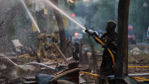  Rescue workers try to put out a fire at a residential building after a Russian strike on Kyiv, Ukraine, on Sunday, May 24, 2026.