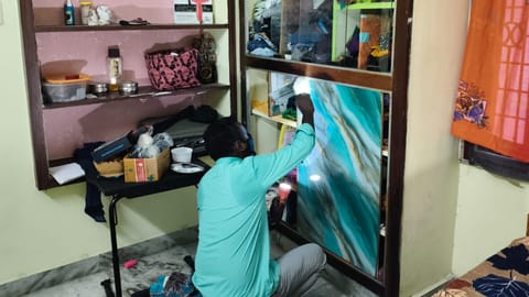 A fingerprint expert collects evidence at the house where the latest robbery took place