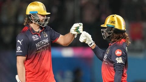 Royal Challengers Bengaluru's captain Rajat Patidar, right, with Tim David celebrates his half century during the Indian Premier League (IPL) 2026 T20 first qualifier cricket match between Royal Challengers Bengaluru and Gujarat Titans