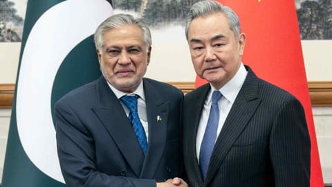 Chinese Foreign Minister Wang Yi, right, receives Mohammed Ishaq Dar, Pakistan's deputy prime minister and foreign minister, in Beijing