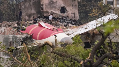Remains of the crashed Air India plane lie on a building, in Ahmedabad