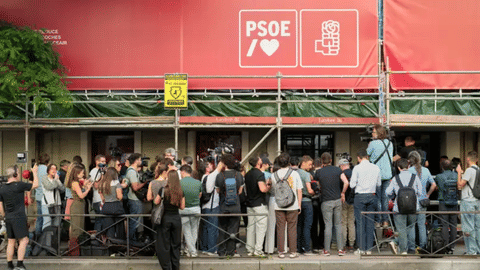 Journalists gather outside the headquarters of Spain’s ruling Socialist Party as police search the building in Madrid, Wednesday, May 27, 2026.