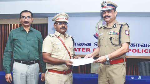 GCP commissioner Amalraj issues a certificate of appreciation to one of the special team officers