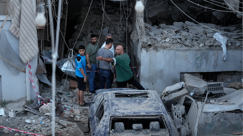 People gather outside a destroyed apartment that was hit in an Israeli airstrike in the southern port city of Sidon, Lebanon, Thursday, May 28, 2026.