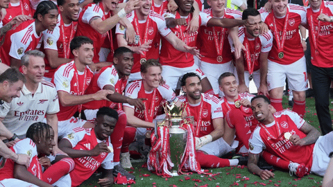 Arsenal players celebrate their Premier League title with the trophy after the English Premier League soccer match between Crystal Palace and Arsenal in London