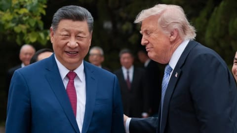 US President Donald Trump, right, speaks with Chinese President Xi Jinping