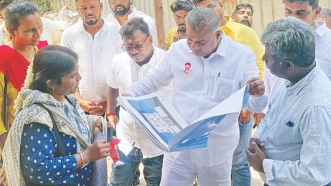 WRD Minister Anand reading a map during a surprise visit