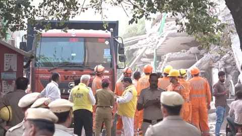 NDRF and police personnel during a rescue operation after a three-storey commercial building collapsed on Saturday evening near the Saket metro station, in New Delhi, Sunday, May 31, 2026
