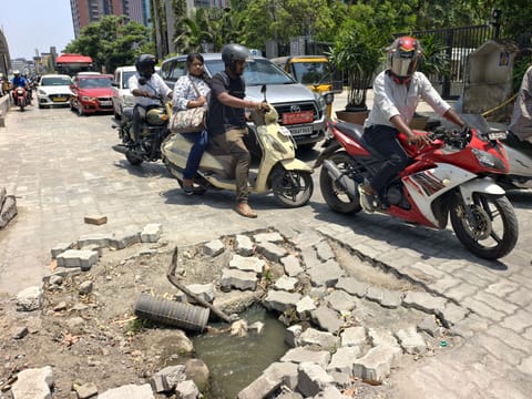 Motorists try to avoid open drains on OMR service road near World Trade Centre