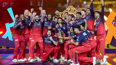 Royal Challengers Bengaluru's players celebrate with the tournament trophy during the presentation ceremony after winning the Indian Premier League (IPL) 2026 title, in Ahmedabad