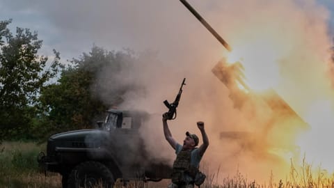A soldier reacts as an MRLS BM-21 "Grad" fires at the Russian positions near Kostiantynivka, Donetsk region, Ukraine
