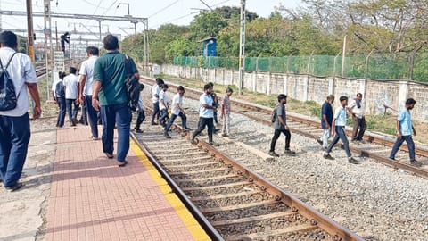 Passengers crossing the tracks to avoid walking a longer route