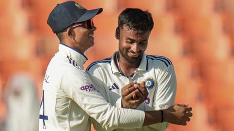India's Manav Suthar, right, celebrates with Yashasvi Jaiswal after taking the wicket of Afghanistans's Afsar Zazai on day two of a Test cricket match between India and Afghanistan, in Mullanpur, Sunday, June 7, 2026