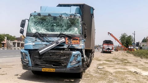 Damaged remains of a truck after it collided with a passenger bus on the Agra-Delhi Highway, in Mathura