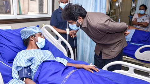 Andhra Pradesh Deputy Chief Minister Pawan Kalyan meets a person injured in the Rashtriya Ispat Nigam Ltd (Vizag Steel Plant) accident