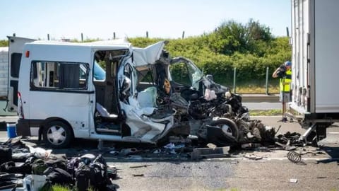 A damaged minibus is seen on the M1 motorway near Gyor, Hungary,after the vehicle ran into a truck that had come to a stop due to a previous accident.
