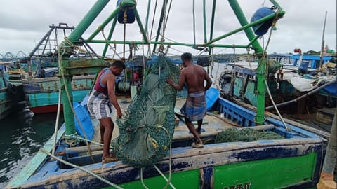 Fishermen are preping their boat.