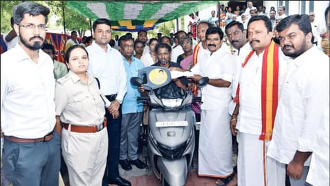Minister Nirmalkumar handing over welfare aid to a beneficiary in Theni