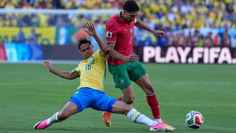 Brazil's Douglas Santos, left, challenges Morocco's Achraf Hakimi during the World Cup Group