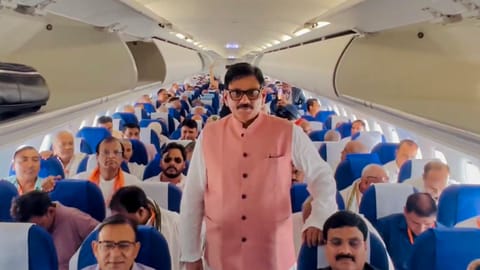 BJP MLA Dhirendra Singh, centre, with farmers from the Jewar area onboard the inaugural ceremonial flight from Noida International Airport to Lucknow, in Jewar, Uttar Pradesh