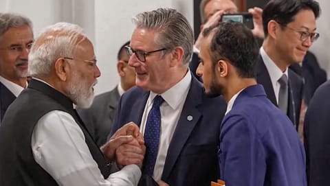 Prime Minister Narendra Modi interacts with Britain's Prime Minister Keir Starmer during a working session at the G7 Summit, in Evian-les-Bains