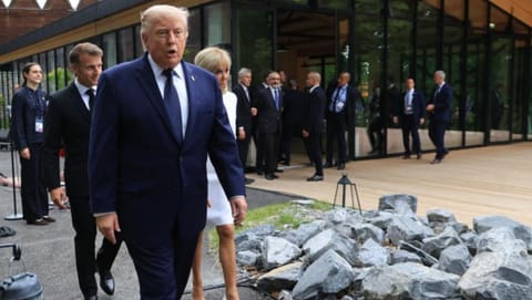 US President Donald Trump walks after posing for a family photo photograph during a gala dinner as part of the G7 summit, in Evian-les-Bains