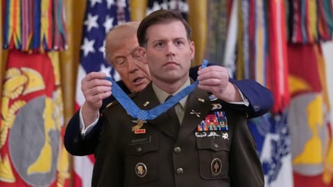 US President Donald Trump presenting a medal to a military official