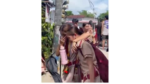 Students react after a shooting incident at the San Jose National High School in Tacloban city, Philippines
