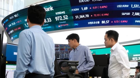 Currency traders work at the foreign exchange dealing room of the Hana Bank headquarters in Seoul, South Korea