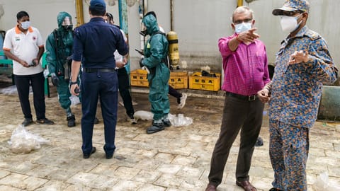 National Disaster Response Force (NDRF) personnel arrive at a seafood export unit following an ammonia gas leak, in Manjangaranai, Tiruvallur