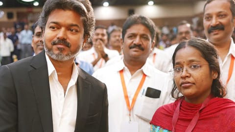 Chief Minister C Joseph Vijay handing over the appointment order to R Akshayalakshmi, a recruit in her 40th week of pregnancy, at an event in Kalaivanar Arangam on Wednesday