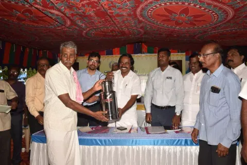Minister Mano Thangaraj giving away a milk can to a beneficiary  in Coimbatore on Thursday