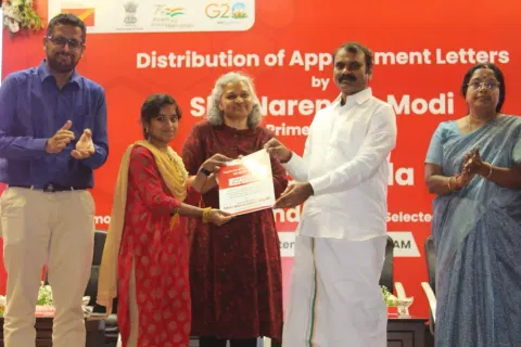 Union Minister L Murugan handing over an appointment letter Coimbatore on Tuesday