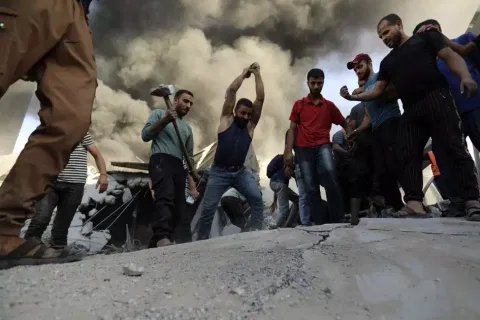 Palestinians striking concrete in search for survivors under rubble in Gaza, Saturday