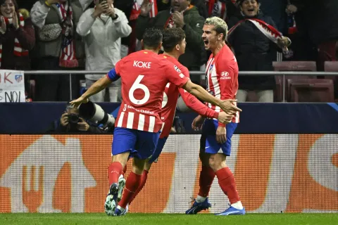 Antoine Griezmann (R) celebrates with teammates after scoring a goal