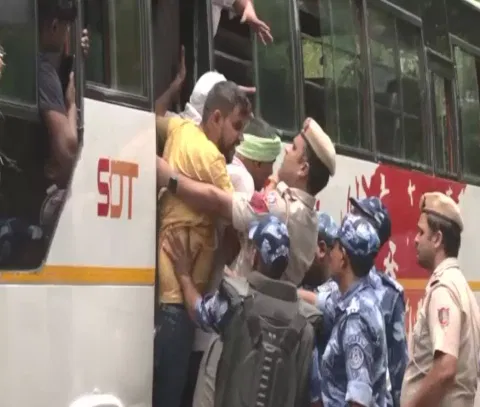 Security personnel detains protesting wrestlers as they move towards new Parl