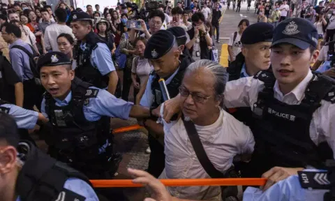 A public member taken away by the cops. AP