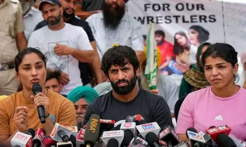Wrestlers Sakshi Malik, Vinesh Phogat, and Bajrang Punia speak with the media during their protest at Jantar Mantar in New Delhi. (PTI)