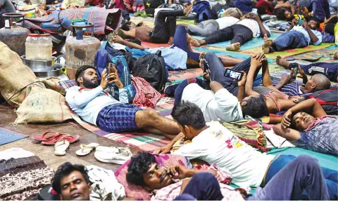People evacuated from Kandla port at a shelter on Tuesday