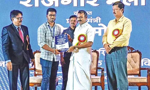 Union Minister L Murugan distributing job orders in Tiruchy on Tuesday