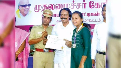 Mano Thangaraj hands over certificate to a sportsperson during the CM Trophy event