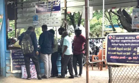 Commuters made to wait at the two-wheeler parking lot near Tambaram railway station