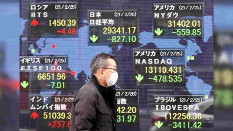 A man walks past a stock quotation board at a brokerage in Tokyo, Japan (Photo: Reuters)