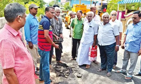 Residents peeling off the tar from the newly-laid road in Thanjavur on Monday