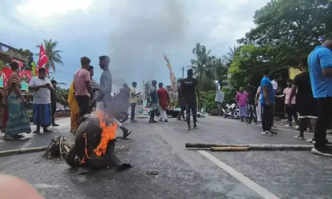 Supporters block a road in protest against the killing of an independent candidate during panchayat polls, at Barasat in North 24 Parganas district, Saturday. (PTI)