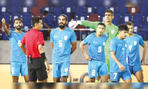 Indian players surround the referee after penalty being awarded for the challenge on Aymen Ghadhban&nbsp;
